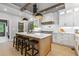 Well-designed kitchen with a spacious center island, bar stools, and modern pendant lighting at 12995 Bucksport Dr, Roswell, GA 30075