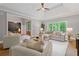 Comfortable living room with a large sectional sofa, abundant natural light, and a view into the entry hall at 12995 Bucksport Dr, Roswell, GA 30075