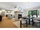 Open concept living space showcasing dining and living areas with a cozy fireplace and seamless flow to the kitchen at 12995 Bucksport Dr, Roswell, GA 30075