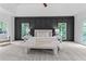Stunning main bedroom features a tray ceiling, accent wall, and abundant natural light at 12995 Bucksport Dr, Roswell, GA 30075