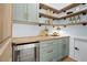 Well-stocked pantry with custom shelves, butcher block countertop, stainless steel wine cooler and stylish decor at 12995 Bucksport Dr, Roswell, GA 30075