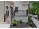 Cozy porch area with railing and manicured landscaping offers a welcoming entrance at 12995 Bucksport Dr, Roswell, GA 30075