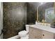Chic powder room with designer wallpaper, an elegant vanity, and stylish fixtures, adding a touch of luxury at 12995 Bucksport Dr, Roswell, GA 30075