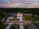 Aerial view of an estate home and manicured grounds and circular driveway at dusk at 157 Shadburn Ferry Rd, Buford, GA 30518