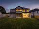 Night view of the backyard with a covered patio and expansive lawn at 157 Shadburn Ferry Rd, Buford, GA 30518