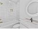 Modern bathroom with marble tile shower, soaking tub, and illuminated mirror at 157 Shadburn Ferry Rd, Buford, GA 30518
