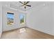 Beautiful bedroom with tray ceiling, ceiling fan, and large windows offering great views at 157 Shadburn Ferry Rd, Buford, GA 30518