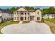 Beautiful two-story home with a circular driveway and manicured landscaping at 157 Shadburn Ferry Rd, Buford, GA 30518