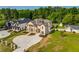 A stately two-story home with lush landscaping and a circular driveway at 157 Shadburn Ferry Rd, Buford, GA 30518