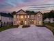 Stunning two-story brick home featuring a spacious driveway and well-manicured lawn at 157 Shadburn Ferry Rd, Buford, GA 30518