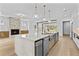 Spacious kitchen features a large island with a built in sink, stone countertops, and stainless steel appliances at 157 Shadburn Ferry Rd, Buford, GA 30518