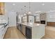 Spacious kitchen features a large island, stainless steel appliances, stone countertops, and a breakfast nook at 157 Shadburn Ferry Rd, Buford, GA 30518