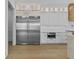 Modern kitchen with stainless steel appliances, custom white cabinets, and an oversized refrigerator at 157 Shadburn Ferry Rd, Buford, GA 30518