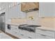 Modern kitchen with stainless steel appliances, stone countertops, custom vent hood and pot filler at 157 Shadburn Ferry Rd, Buford, GA 30518