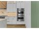 Modern kitchen with stainless steel double ovens and white shaker style cabinets at 157 Shadburn Ferry Rd, Buford, GA 30518