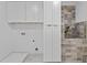 Functional laundry room with tile floors, cabinets, and walk-in shower area at 157 Shadburn Ferry Rd, Buford, GA 30518