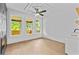 Modern living room boasts hardwood floors, ceiling fan, and view to outdoor balcony at 157 Shadburn Ferry Rd, Buford, GA 30518