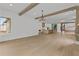 Open-concept living area showcasing beams and connection to a modern kitchen at 157 Shadburn Ferry Rd, Buford, GA 30518