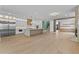 Open-concept space featuring a modern kitchen and a fireplace, all with wood floors at 157 Shadburn Ferry Rd, Buford, GA 30518