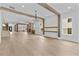 Open-concept living area showcasing wood beams and connection to other rooms at 157 Shadburn Ferry Rd, Buford, GA 30518