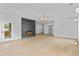 Modern open living room with custom fireplace and access to outdoor living space at 157 Shadburn Ferry Rd, Buford, GA 30518