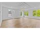 Open living room featuring hardwood floors, recessed lighting, and large windows showcasing outdoor views at 157 Shadburn Ferry Rd, Buford, GA 30518
