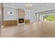 Bright living area with a brick fireplace, wood floors, and natural light at 157 Shadburn Ferry Rd, Buford, GA 30518