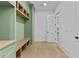 Mudroom with custom green built in cabinets, shelves and a wooden bench at 157 Shadburn Ferry Rd, Buford, GA 30518