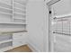 Pantry area with white cabinets and wooden countertop with view to the garage at 157 Shadburn Ferry Rd, Buford, GA 30518