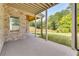 Spacious covered patio overlooking a lush green yard and trees at 157 Shadburn Ferry Rd, Buford, GA 30518