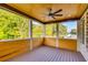 Screened-in porch features a ceiling fan and wood ceiling overlooking the backyard at 157 Shadburn Ferry Rd, Buford, GA 30518