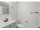 Modern bathroom with gray vanity, toilet, and shower with light gray tiling at 169 Peyton Sw Pl, Atlanta, GA 30311