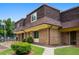 View of a brick townhouse with mature trees and a well-maintained lawn at 169 Peyton Sw Pl, Atlanta, GA 30311
