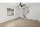 Bright living room featuring wood floors, ceiling fan, and staircase at 169 Peyton Sw Pl, Atlanta, GA 30311