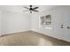 Bright living room featuring wood floors, a ceiling fan, and a large window at 169 Peyton Sw Pl, Atlanta, GA 30311
