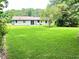 Well-manicured backyard with a lush green lawn and mature trees at 4074 Green Hawk Trl, Decatur, GA 30035