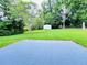 A large, grassy backyard features a shed and mature trees at 4074 Green Hawk Trl, Decatur, GA 30035
