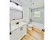 Modern bathroom features white vanity and patterned-tile shower-tub at 4074 Green Hawk Trl, Decatur, GA 30035