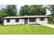 Charming brick ranch-style home with a vibrant blue door and well-manicured lawn at 4074 Green Hawk Trl, Decatur, GA 30035