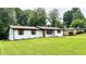 Beautifully landscaped front yard featuring a well-maintained lawn of a charming ranch home at 4074 Green Hawk Trl, Decatur, GA 30035