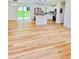 Bright, open-concept living area featuring wood-look flooring, and modern kitchen at 4074 Green Hawk Trl, Decatur, GA 30035