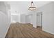Spacious basement area with wood-look flooring and modern lighting fixtures at 4990 Sawgrass Nw Pl, Acworth, GA 30102