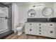 Bathroom featuring double sinks, modern mirrors, and a shower at 4990 Sawgrass Nw Pl, Acworth, GA 30102
