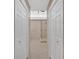 Neutral tiled bathroom with a glass enclosed shower and double closets at 4990 Sawgrass Nw Pl, Acworth, GA 30102
