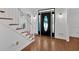 Open foyer with hardwood floors, decorative front door and a staircase at 4990 Sawgrass Nw Pl, Acworth, GA 30102