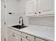Utility sink with marble countertops and stainless steel faucet and white cabinets at 4990 Sawgrass Nw Pl, Acworth, GA 30102