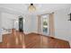 Cozy living room with hardwood floors, large window, and decorative chandelier at 4990 Sawgrass Nw Pl, Acworth, GA 30102