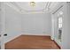 Bright living room with hardwood floors, decorative crown molding and large windows at 4990 Sawgrass Nw Pl, Acworth, GA 30102
