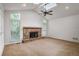 Bright living room featuring a stone fireplace, ceiling fan, and skylight for ample natural light at 4990 Sawgrass Nw Pl, Acworth, GA 30102