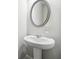 Bathroom featuring a pedestal sink with mirror, dispenser, and neutral color palette at 791 Belrose Dr, Smyrna, GA 30080